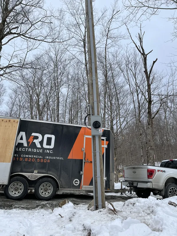 Trailer in snow near pole